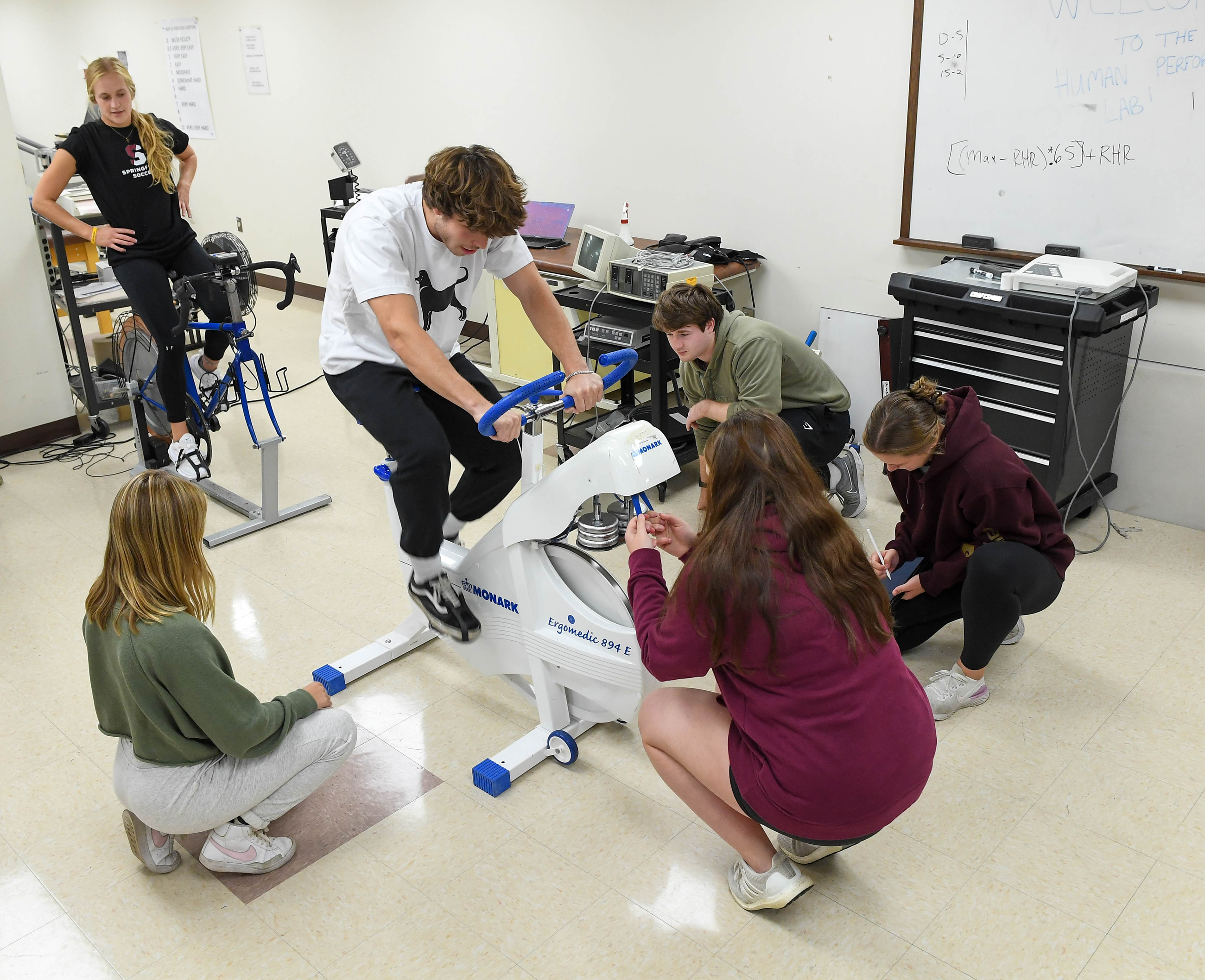 male scientist with female athlete on wingate bicycle
