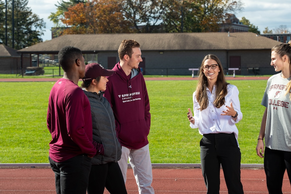 Springfield College Assistant Professor of Exercise Science Kathleen Mellano works with students on the Blake Track